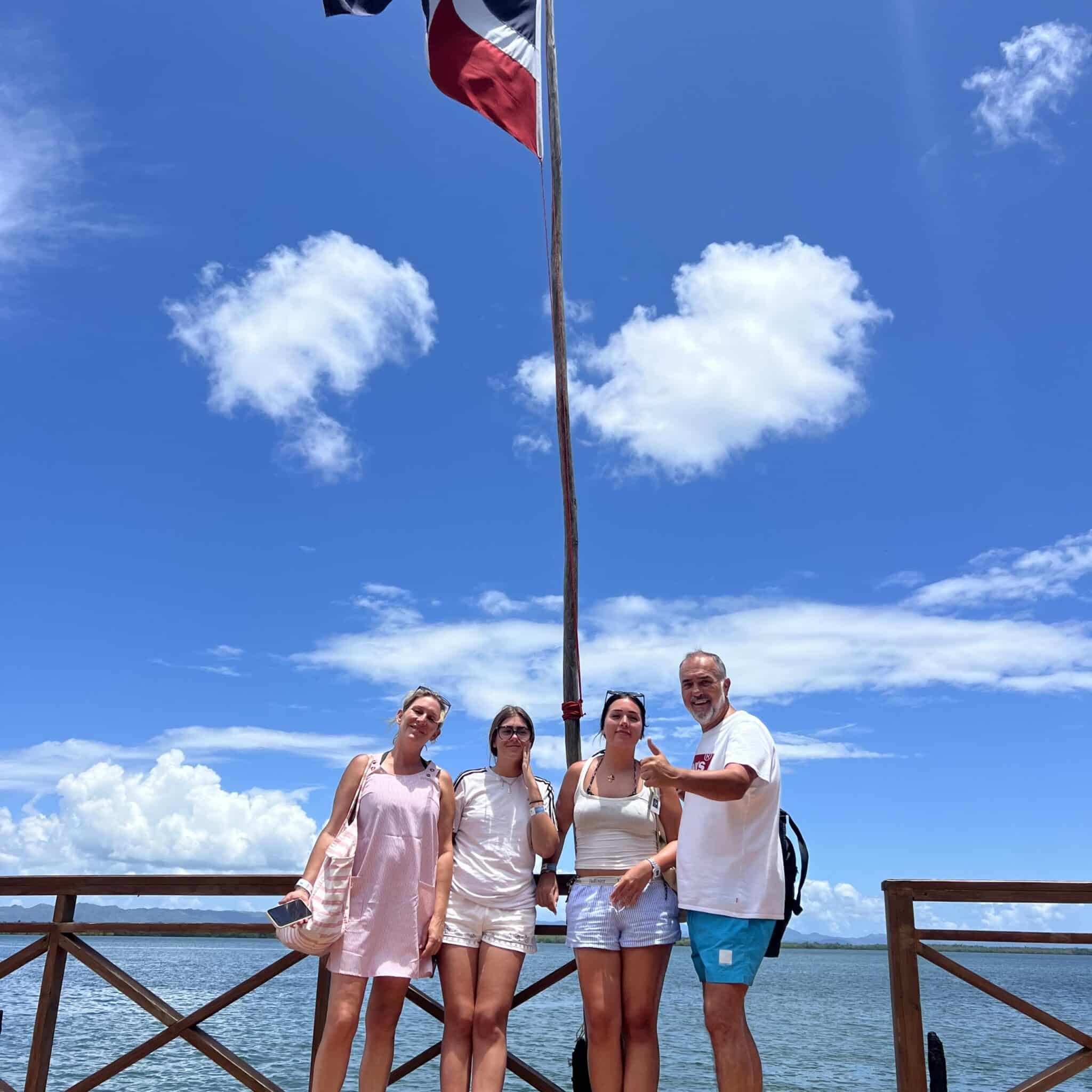 Family posing near a Dominican Republic flag